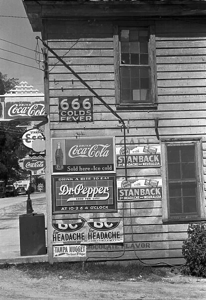 HALIFAX: STORE, 1938. Side of a rural general store with soft drink and medicine advertisements, Halifax, North Carolina. Photograph by John Vachon in April 1938