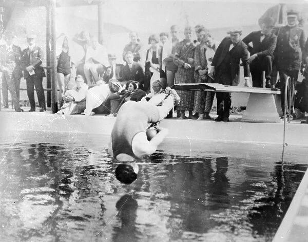 HARRY HOUDINI (1874-1926). American magician. Houdini diving into a swimming pool