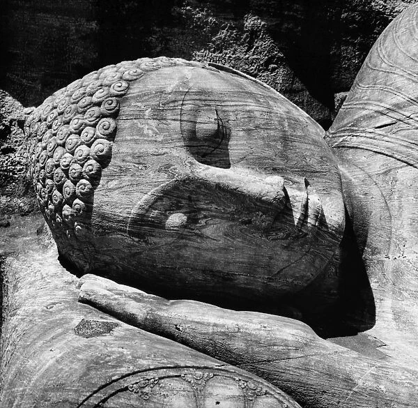 Head of the 12th century giant reclining Buddha figure carved out of granite rock at Gal Vihara, Sri Lanka. Photogaph, late 20th century