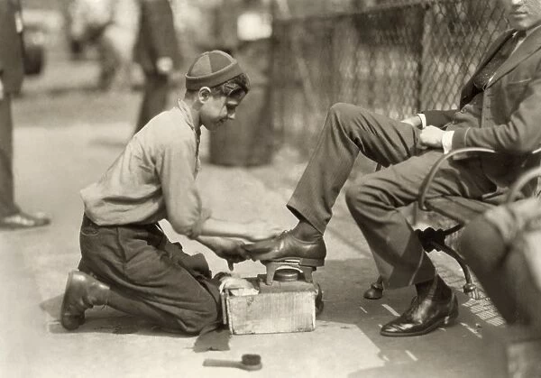 HINE: BOOTBLACK, 1924. A 12-year-old bootblack shining shoes in Bowling Green, New York City