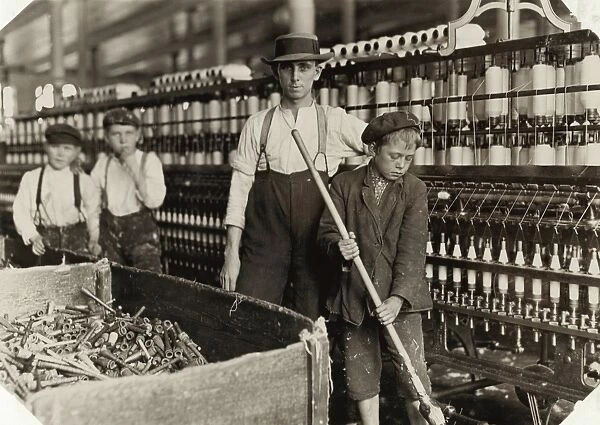 HINE: CHILD LABOR, 1908. A young sweeper and doffers with a supervisor in the Lancaster