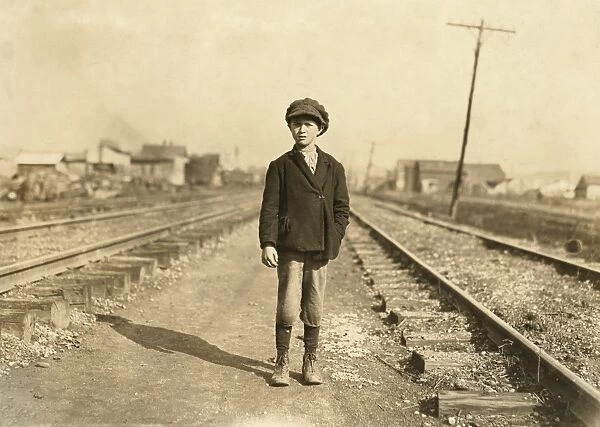 HINE: CHILD LABOR, 1908. A young worker walking along the train tracks to Maple Mills