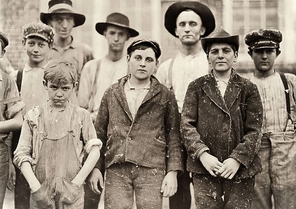HINE: CHILD LABOR, 1909. Young textile mill workers with a supervisor at the Payne
