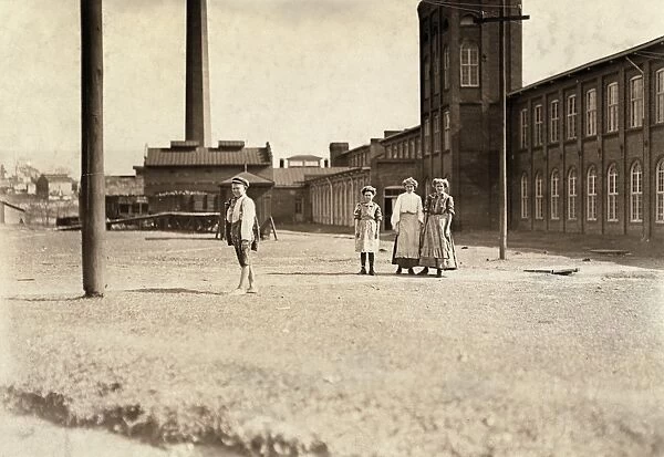HINE: CHILD LABOR, 1909. Young textile mill workers in front at the Manchester