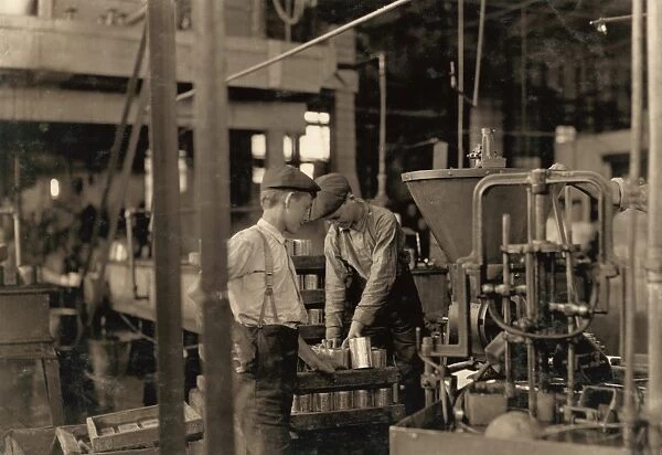 HINE: CHILD LABOR, 1909. Young workers using a dangerous canning machine at the J