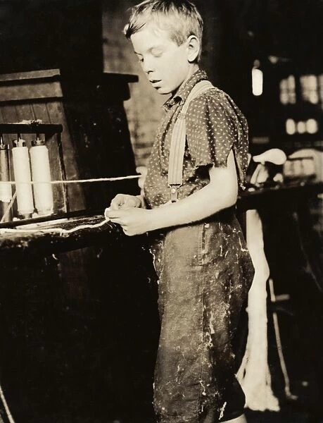 HINE: CHILD LABOR, 1910. A young worker making bands at a cotton mill in North Pownal, Vermont