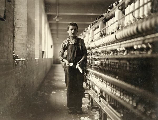 HINE: CHILD LABOR, 1911. A bobbin boy in the spinning room of a textile mill in Chicopee