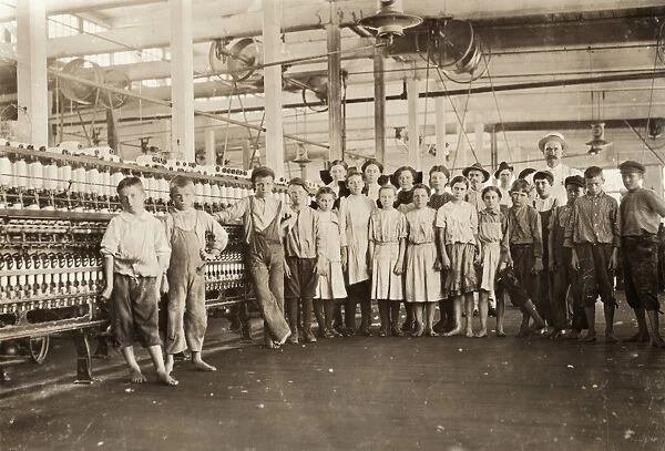 HINE: CHILD LABOR, 1911. A mill supervisor with a group of young workers all under