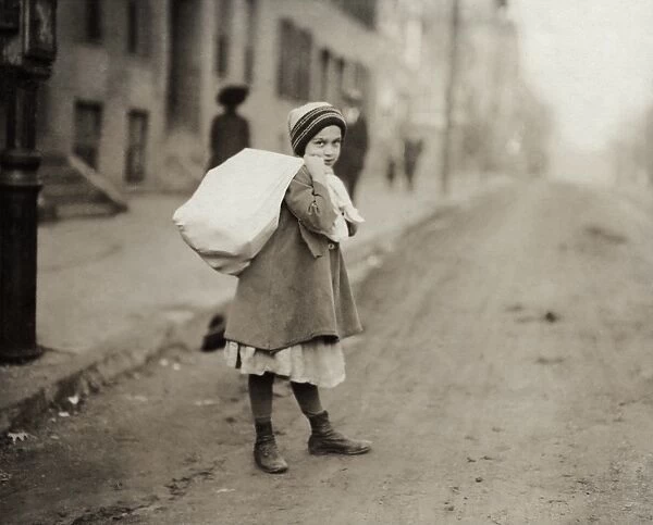 HINE: CHILD LABOR, 1912. A young girl carrying a sack of hose supporters home in Worcester