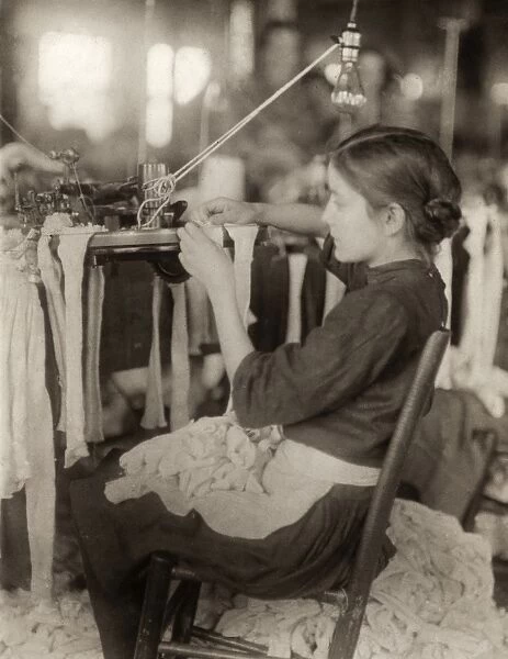 HINE: CHILD LABOR, 1913. A young worker using textile machinery at the Cherokee