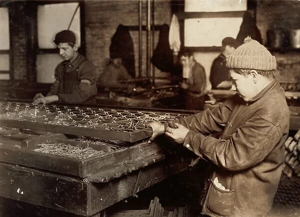 HINE: CHILD LABOR, 1917. Boys linking bedsprings in a mattress factory in Boston, Massachusetts