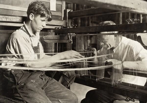 HINE: CHILD LABOR, 1924. A young worker and an older worker weaving silk at the