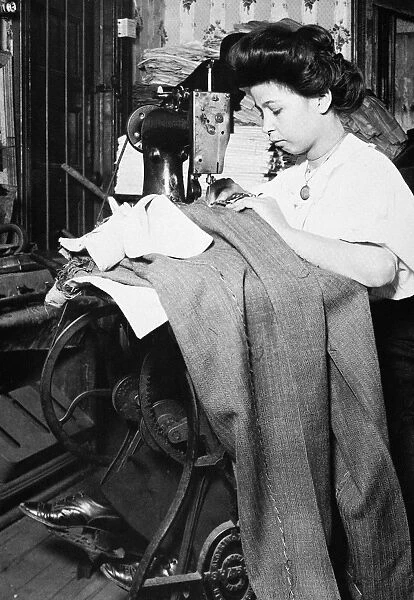 HINE: GARMENT MAKER. Women sewing garments at a sweatshop in America