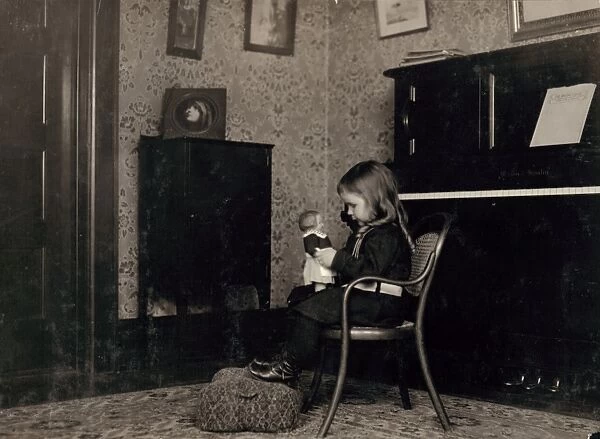 HINE: GIRL WITH DOLL, 1912. A young girl playing with a Campbell Kid doll, at a