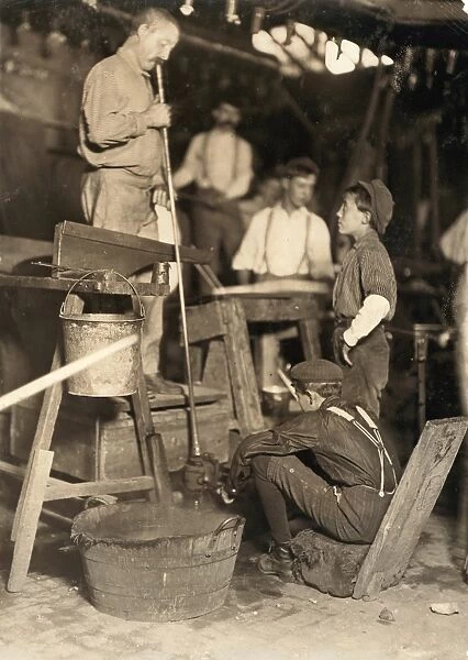 HINE: GLASS WORKERS, 1908. A glass blower and mold boy at the Seneca Glass Works in Morgantown