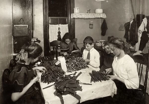 HINE: HOME INDUSTRY, 1912. A Jewish family making garters in the kitchen of their