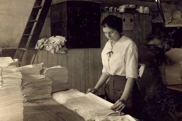 HINE: LAUNDRY, 1917. A 15-year-old girl folding laundry at the Bonanno Laundry in Boston