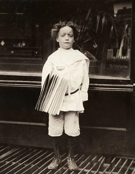HINE: NEWSBOY, 1910. A newsboy selling newspapers around saloon entrances on the