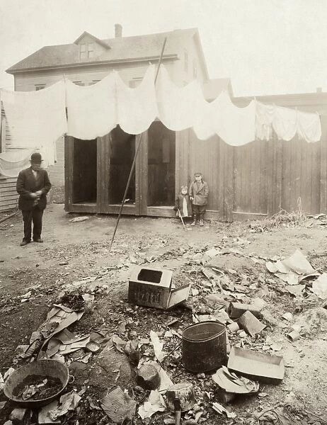 HINE: OUTHOUSES, 1912. Outhouses in the backyard on Borden Street in Providence, Rhode Island