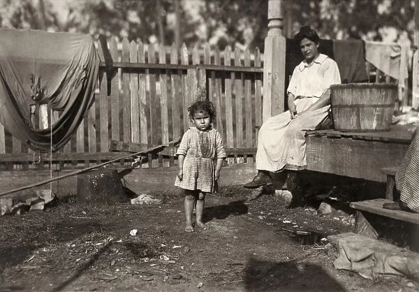 HINE: POVERTY, 1911. An impoverished mother with her three-year-old daughter