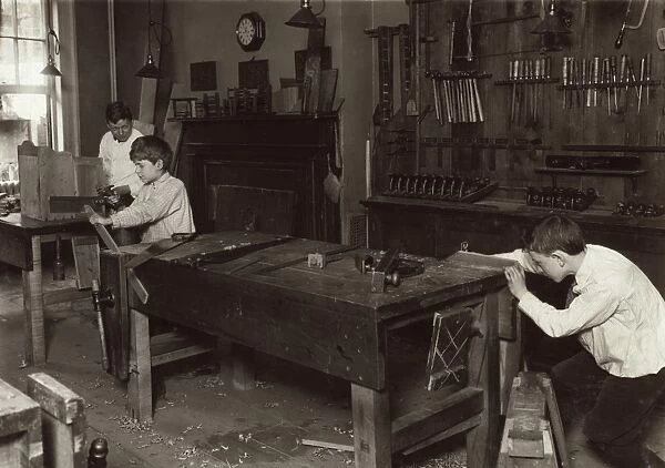 HINE: SHOP CLASS, 1910. Boys learning carpentry in a woodwork shop class at the Henry St