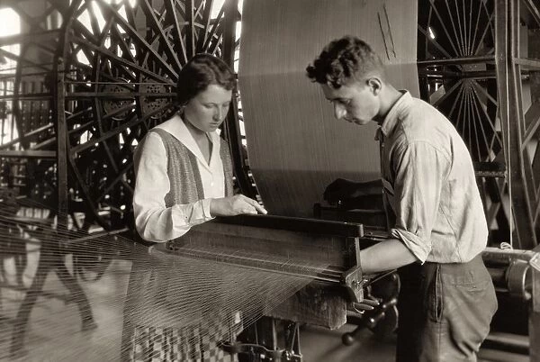 HINE: SILK MILL, 1924. A boy and a girl working a loom at the Cheney Silk Mills