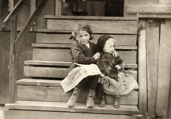 HINE: SISTERS, 1911. A young girl taking care of her baby sister while her family