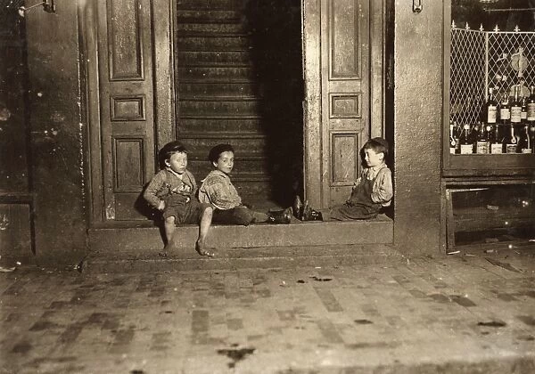 HINE: STREET BOYS, 1909. Three boys hanging out in a doorway late at night in Boston