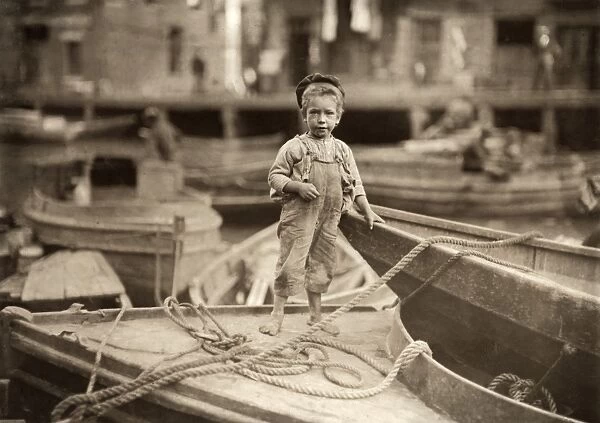 HINE: TRUANT, 1909. A young truant hanging around fishing boats in the harbor during