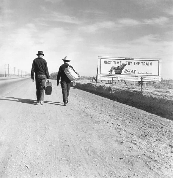 HITCHHIKERS, 1937. Two hitchhikers on their way to Los Angeles, California. Beside them