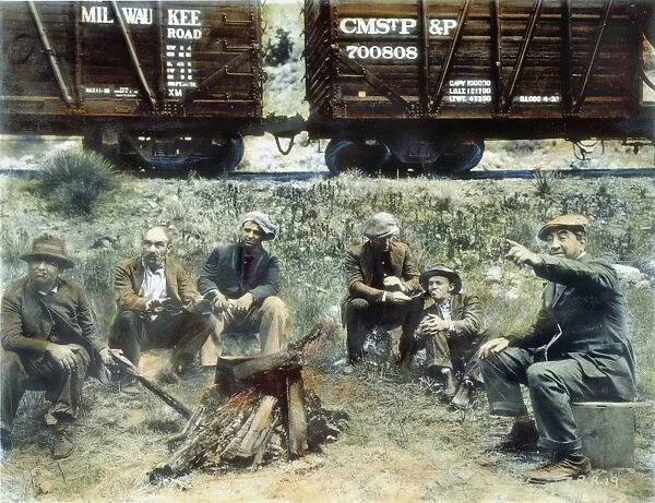HOBOES, 1920. A group of hoboes in the American Midwest. Oil over a photograph, 1920s
