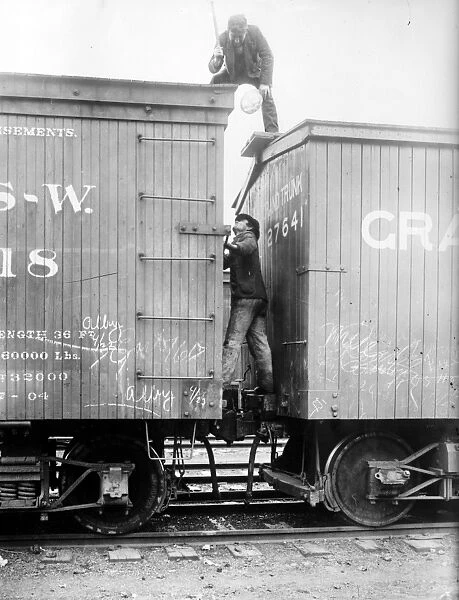 HOBOS, c1915. Hoboes fighting between railroad cars. Photograph, c1915