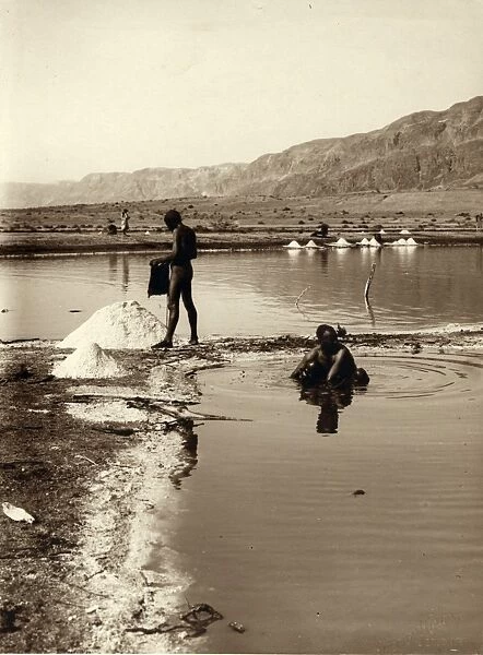 HOLY LAND: DEAD SEA. Two men collecting salt from the Dead Sea. Photograph, c1920