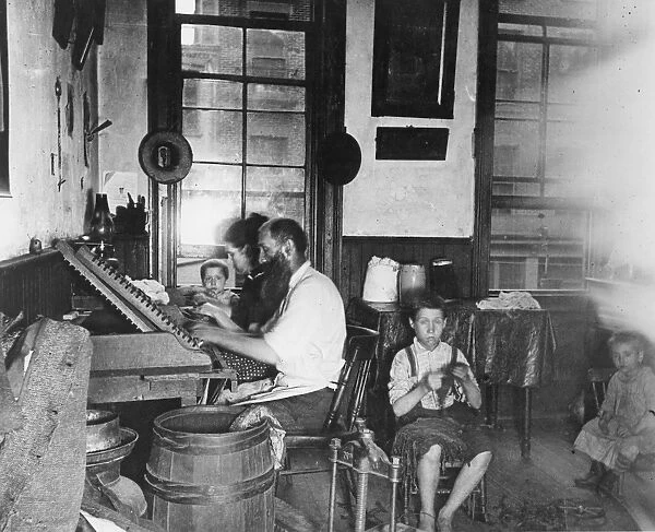 HOME INDUSTRY, 1890. A family of Bohemian cigarmakers at work in their tenement