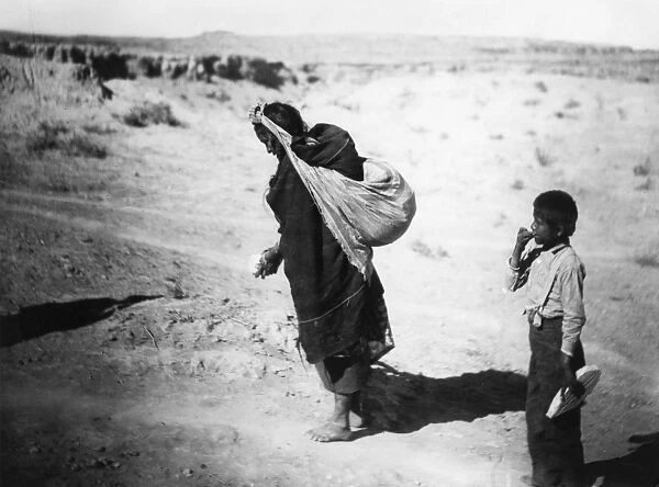 HOPI FARMER, c1900. A Hopi woman sowing grain at a pueblo in northeastern Arizona