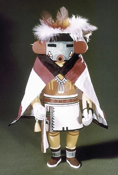 HOPI KACHINA DOLL. Talavai (Morning Singer), a Hopi spirit or Kachina, dressed in a cape and headdress. Carved wooden doll from Arizona