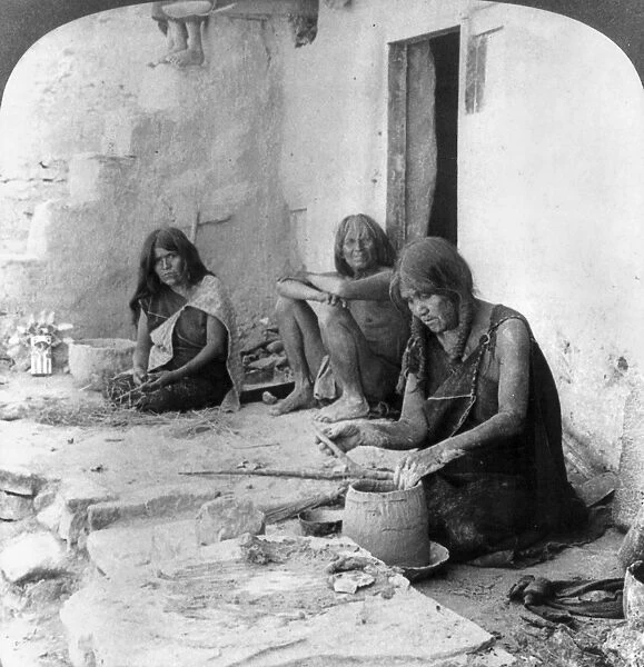 HOPI POTTERS, c1903. A Hopi woman coiling clay into a ceramic vessel at Oraibi, Arizona