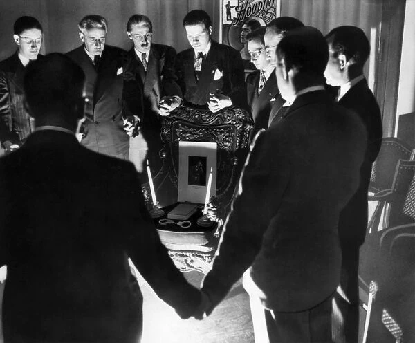 HOUDINI SEANCE, 1936. A group of magicians conducting a seance in Detroit, Michigan