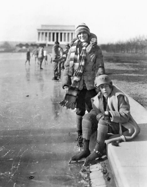 ICE SKATERS. Two women identified as Celene DuPuy and Abbey Jackson (seated) wearing ice skates