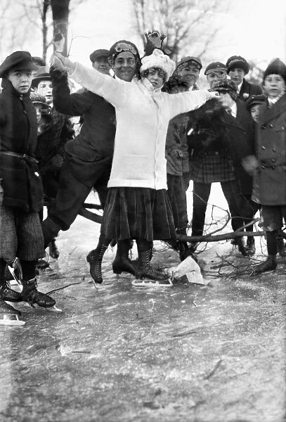 ICE SKATING. Zynaide DeLanoy with a group posing while ice skating. Photograph