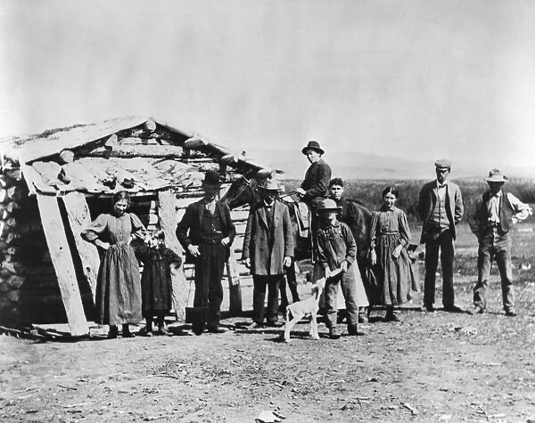 IDAHO: SETTLERS, c1882. A group of settlers standing outside a log cabin in American Falls, Idaho