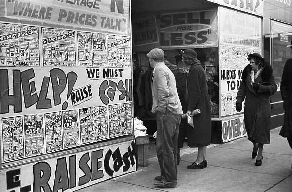 ILLINOIS: SHOPPERS, 1939. Pedestrians in front of a storefront with signs pleading