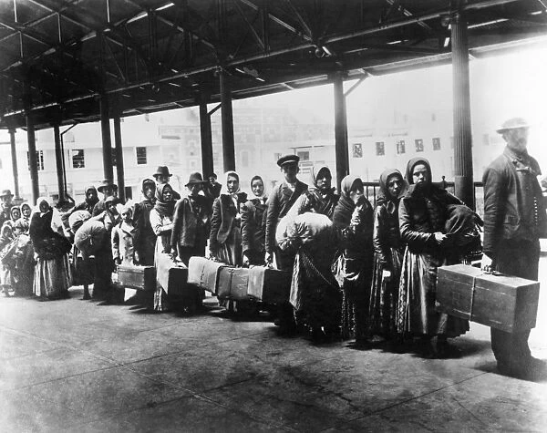 IMMIGRANTS: ELLIS ISLAND. Immigrants arriving at Ellis Island, c1900