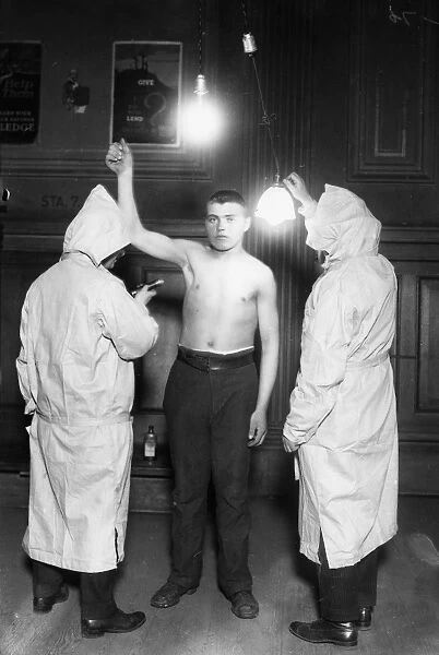 IMMIGRATION: EXAM, 1921. Members of the New York City Health Department examining an immigrant