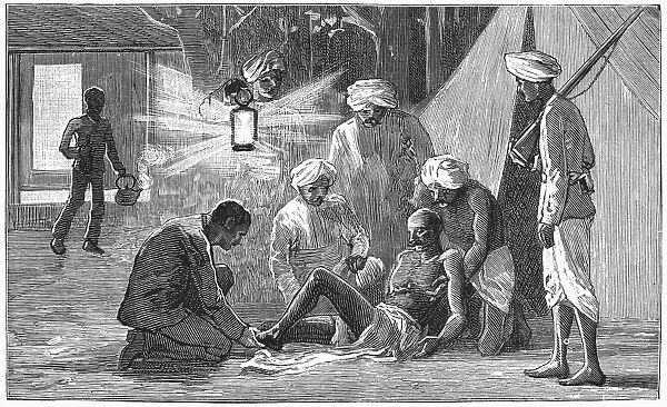 INDIA: SNAKE, 1887. A police sepoy being treated for a snakebite in India. Wood engraving