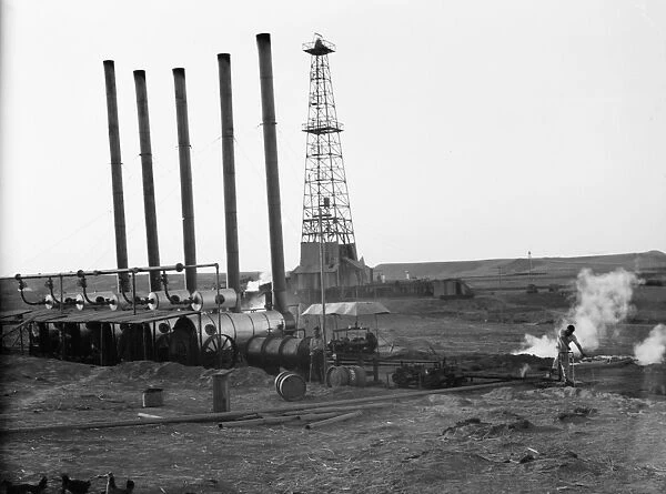 IRAQ: OIL FIELD, 1932. A drilling tower and machinery at an oil field in Iraq. Photograph