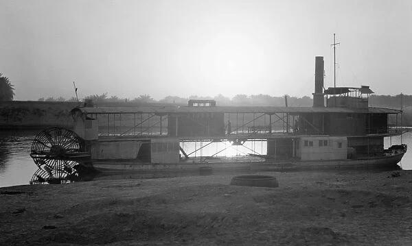 IRAQ: RIVERBOAT, 1932. Riverboat photographed during sunset on a river in Iraq, 1932