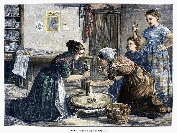 IRELAND: HAND MILL, 1874. Irish peasant women using a hand mill to grind cereal grain into flour. Wood engraving, English, 1874