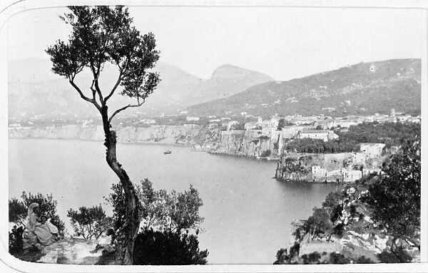 ITALY: SORRENTO, c1869. A woman and child seated on an overlook above the town of Sorrento