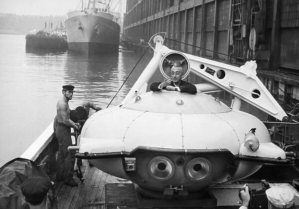 JACQUES COUSTEAU (1910-1997). French oceanographer. Cousteau climbing into his Diving Saucer on board the Calypso docked in New York Harbor in August 1959